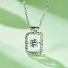 An eye-catching round moissanite dances with ease at the center of this appealing women's necklace, expressing your unstoppable love. Additional round gem set in sterling silver frame the center. Features Moissanite was originally found in meteorites(Chemical name: Silicon Carbide). It was first discovered in 1893, while a scientist was examining meteor samples from a crater in Arizona. After many years, the experts has been recreated moissanite in the laboratory, that make the gemstone with fri Pave Necklace, Women's Necklace, Silicon Carbide, Moissanite Necklace, Moissanite Jewelry, Round Moissanite, Timeless Jewelry, Silver Frame, Perfume Bottle