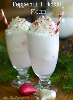 two glasses filled with whipped cream and sprinkles on top of a table