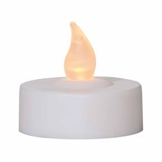 a white candle that is on top of a round base with a light in the middle