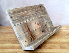 a piece of wood sitting on top of a wooden table next to a wall and floor