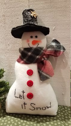 a snowman with a black hat and scarf