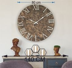 a large clock on the wall above a dresser