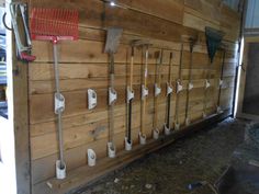 there are many different types of tools on the wall in this room with wood paneling