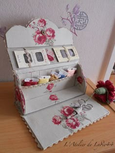 an old fashioned sewing box with flowers on it