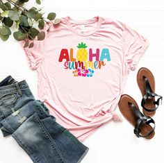 "Aloha Summer Hibiscus Shirt, Aloha Summer T-Shirt, Hawaii Vacation Shirt, Summer Trip Shirt, Aloha Tee, Cute Aloha Shirt, Tropical Shirt ☀️☀️☀️☀️☀️ Everything in our shop is hand crafted and made to order. If you want different color or size contact me! If you would like something custom made to fit your personal style please message me and I will do everything to get you that something special. ---How To Order--- ⭐️Please, check and review all photos ⭐️Choose your t-shirt size and color ⭐️Ente Multicolor Hawaiian T-shirt For Summer, Multicolor Hibiscus Print Summer Shirt, Multicolor Hawaiian T-shirt For Beach Season, Pink Hawaiian Short Sleeve T-shirt, Hawaiian Multicolor Tops With Sublimation Print, Multicolor Hibiscus Print Short Sleeve Tops, Multicolor Short Sleeve Tops With Hibiscus Print, Tropical Print Short Sleeve T-shirt, Casual Multicolor Top With Hibiscus Print