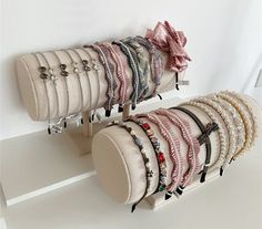 several bracelets are hanging on the wall next to each other