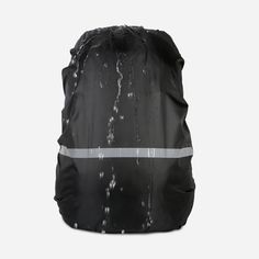 a black and white backpack with water running down the front, on a grey background