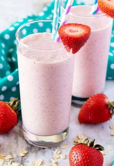 two glasses filled with smoothie and strawberries