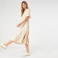 Say hello to the Margaux Tiered Ruffle Sleeve Dress, the epitome of effortless style! With its relaxed fit, this dress ensures you feel comfortable and confident all day long. The longer ruffle sleeves add a chic twist, while the decorative buttons give it a hint of sophistication. Plus, it's equipped with pockets to keep your essentials close at hand. Perfect for both casual outings and special events, this dress is a must-have in your wardrobe! Materials: Viscose. Casual Flutter Sleeve Midi Dress For Spring, Casual Flutter Sleeve Midi Dress For Brunch, Flowy Midi Dress With Ruffle Sleeves For Beach, Midi Dress With Ruffle Hem And Ruffle Sleeves, Casual Midi Dress With Flutter Sleeves For Brunch, Casual Midi Dress With Flutter Sleeve And Ruffle Hem, Casual Midi Dress With Flutter Sleeves And Ruffles, Daywear Midi Dress With Ruffle Hem And Sleeves, Flowy Ruffle Sleeve Tiered Vacation Dress