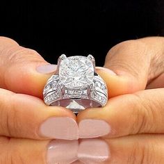 a woman holding a diamond ring in her hands