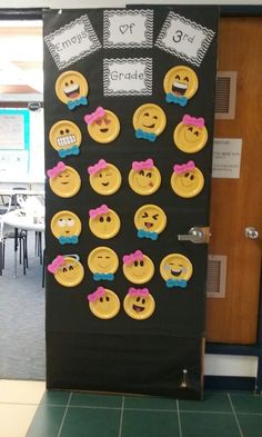 a door decorated with yellow and pink smiley face buttons on black paper, which reads instagram