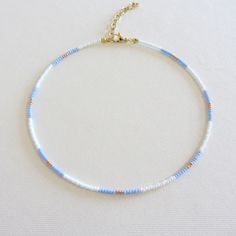 Blue white and gold beaded necklace, Seed bead choker, 18k gold necklace, Long necklaces for women The clasp and chain are made of brass with 18k gold plating, so the necklace will not lose its look over time! Measure the length of your neck with a measuring tape or you can use any string, rope or phone cable, and afterward apply the measurements on a regular ruler. Necklace length is 12 inches with an adjustable 2 inch extension chain. The full length is 14 inches. The necklace is made using size 10/0 Czech beads (approximately 2.3mm.) Cute Seed Bead Necklaces, Glass Bead Necklace Ideas, Beaded Necklace Ideas, Sead Bead Necklace, Small Bead Necklace, Blue And White Necklace, Seed Bead Necklaces, Gold Necklace Long, Seed Beads Necklace