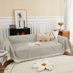 a living room filled with furniture and decor on top of a hard wood floored floor