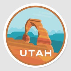 a sticker with the word utah on it in front of a desert landscape and mountains