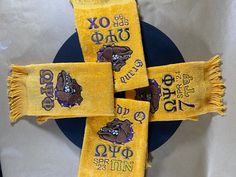 three yellow towels with purple bears on them are sitting on a blue and white plate