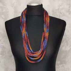 Felted wool orange burgundy blue textile statement necklace made of 100% wool yarn. This is a felted knitted necklace. The woolen necklace was first crocheted and then felted a little. This is a very light natural jewelry. Thanks to the variety of colors, it can be combined with clothes of different colors. It is preferable to wear such necklaces over clothes. The total length of this felted necklace is 92 cm or 36 inches. This crocheted necklace will complement your look and highlight your indi Wool Necklace, Blue Textile, Multicolor Necklace, Knitted Necklace, Felt Necklace, Natural Jewelry, Necklace For Her, Felted Scarves, Felted Wool