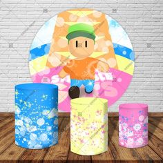 a paper cut out of a man riding a bike in front of three colorful trash cans