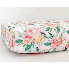 a floral print pillow on a white background