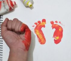 a child's hand and foot prints on paper with crayons next to them