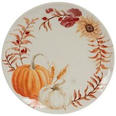 a white plate with an orange pumpkin and sunflower design on the front, surrounded by autumn leaves