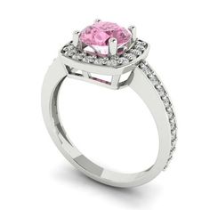 a pink diamond ring with white diamonds on the sides and an oval center stone in the middle