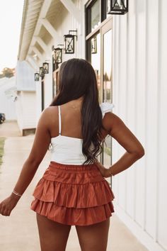 Rusty Brown faux leather tiered ruffle skirt featuring a drawstring tie waistband and built in shorts! Skirt is a petite fit! 45% PU, 55% polyester Model is 5'4" wearing a small. Day Out Tiered Ruffle Shorts, Tiered Ruffle Hem Shorts For Day Out, Brown Tiered Mini Skirt For Summer, Tiered Skort For Day Out, Brown Tiered Ruffle Skirt, Brown Tiered Mini Skirt For Spring, Ruffled Tiered Skort For Day Out, Brown Ruffled Tiered Mini Skirt, Flirty Tiered Skort For Day Out