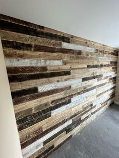 a wall made out of wood planks in an empty room