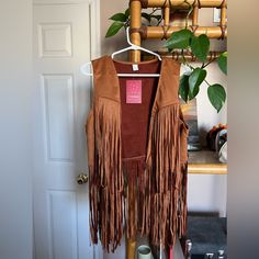 Amazon Sleeveless Vest With Fringe Size Large Brown/Camel Faux Suede Never Worn Brown Fringe Vest For Festival, Sleeveless Brown Vest For Festivals, Festival Fringe Brown Vest, Brown Sleeveless Fringe Vest, Brown Fringe Vest For Fall, Sleeveless Vest, Faux Suede, Camel, Jackets For Women