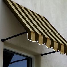 an awning on the side of a building with a window in front of it