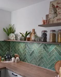 a kitchen with green tiles and wooden counters