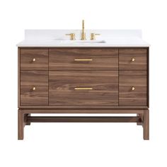 an image of a bathroom vanity with white counter top and gold hardware on the drawers