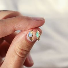 Take your everyday ear stack to the next level with these opal huggie hoops! Not only are they dainty and understated, but these little accessories also pack a punch— bejeweled with a crystal opal for a pop of iridescent color, they'll brighten up your lobes with just the right amount of sparkle. comes with a 14k gold classic earring back sold as a single hoop, unless you select a different quantity from the drop down menu hoops measure 9.7mm in diameter post is 20g made of solid 14k gold, so th 14k Gold Huggie Earrings With Gemstone, Yellow Gold Sterling Silver Huggie Earrings With Birthstone, 14k Gold Huggie Earrings With Birthstone For Anniversary, Fine Jewelry Huggie Earrings With Birthstone, 14k Gold Gemstone Huggie Earrings, Elegant Opal Huggie Jewelry, Minimalist Everyday Opal Jewelry, Minimalist Sterling Silver Gemstone Huggie Earrings, Dainty Birthstone Huggie Earrings For Anniversary