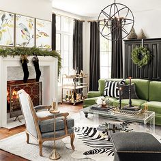 a living room filled with furniture and a fire place in front of a christmas tree