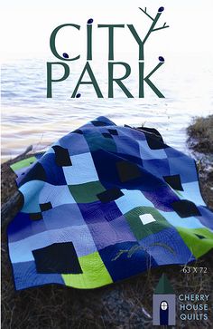 the cover of city park quilt book, featuring an image of a blue and green blanket