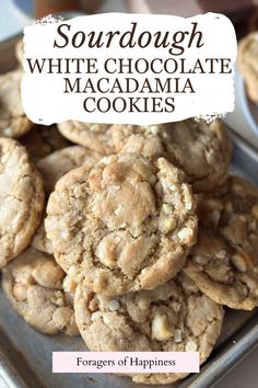 white chocolate macadamia cookies are stacked on top of each other in a pan