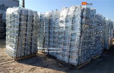 stacks of plastic bags sitting on top of each other in front of an industrial building