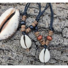 A beautifully simple necklace, with a single cowrie shell, strung on waxed cotton, with wood and Coco beads to set it off... The cord is fully adjustable by means of the slidy knots, and so can be worn at any length.. There is a choice of black beads or brown beads..please make your selection at checkout.. This necklace has a great beach surf vibe to it....the back of the shell is cut flat, so it sits really well ... The shells are approx 2.1 cm long, by 1.5 cm wide, this exact measurements vary as mother nature felt like making !... Please have a look at my shop for more incredible products! https://www.etsy.com/uk/shop/SuzieCalypso Bohemian Necklace With Sliding Knot On Waxed Cord, Adjustable Natural Shell Necklace For Festivals, Adjustable Shell Necklace With Wooden Beads As Gift, Brown Beach Necklace With Adjustable Cord, Natural Color Necklaces With Adjustable Cord For Beach, Natural Color Necklace With Adjustable Cord For Beach, Beach Necklace With Adjustable Cord In Natural Color, Casual Beach Necklace With Sliding Knot, Brown Waxed Cord Beach Necklaces