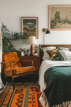 a bed room with a neatly made bed and two pictures on the wall above it