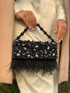 "Vintage-looking luxurious evening clutch is handmade and decorated with rhinestones, crystals, pearl beads, and black ostrich feathers. The small fancy handbag will be a great addition to your amazing look on the Special Day or party! The tiny elegant evening bag will be a lovely accessory not only for the gothic bride but also will suit the bridesmaids' outfit, Mom, or Mother-in-law festive look. And after the celebration will over - you can take it with you to the costume party in Great Gatsb Evening Bags Clutch Night Parties, Hand Made Purse, Embellished Clutch Bag, Black Beaded Bag, Hand Embellished Black Evening Bag, Black Hand Embellished Party Clutch, Vintage Bag Outfit, Elegant Black Embellished Clutch, Embellished Black Clutch Bag