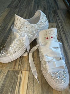 Converse with white pearls and Rhinestones encrusted all over the shoe. !  I can do white pearls or all ivory. (I will do the white unless you ask for something else ) I can also add in some blue rhinestones for your something blue. Or silver rhinestones Please write that in the notes to seller.  I can change the personalization too ! Photo with Mrs Janeau is palest ivory thread  Platform shoes are available in my shop, (search platform) These shoes will sparkle and get noticed across the room! White Embellished Lace-up Sneakers, Pearl-embellished Round Toe Wedding Shoes, Pearl Embellished Wedding Shoes With Round Toe, White Pearl Wedding Shoes For Bridal Shower, Elegant Wedding Sneakers With Rhinestones, Elegant Lace-up Wedding Shoes With Rhinestones, Wedding Lace-up Sneakers With Rhinestones, Elegant White Low-top Wedding Shoes, Wedding White Embellished Sneakers