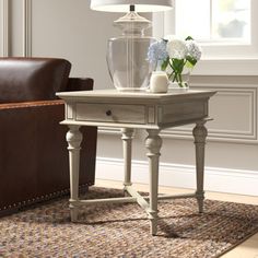 a living room scene with focus on the end table and chair, which has a lamp on it