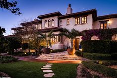 a large white house with steps leading to the front door