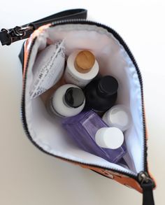 the contents of a purse are neatly packed and ready to be used as makeup products