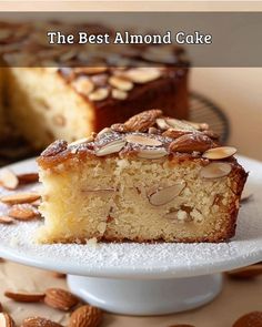 the best almond cake is on a plate and ready to be cut into pieces with another slice in the background