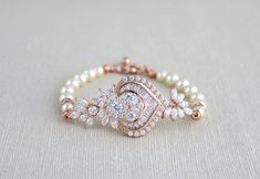 This beautiful rose gold bridal bracelet I created using the most fabulous Rose Gold plated Swarovski Pure brilliance cubic zirconium component that is so full of sparkle and features tons of cz stones in different shapes and sizes. Finished with one strand of Swarovski pearls. Bracelet measures 6.5 inches and extends to 8 inches with an extension chain and has a lobster clasp closure. CZ pendant measures 2.25 x 1 inch. This is an original design by © Treasures by Agnes PLEASE ALLOW APPOX 10 DAY Bridesmaid Pearl Bracelet, Gold Bracelet Wedding, Swarovski Pearls Bracelet, Bridal Bracelet Pearl, Bride Bracelet, Silver Pearl Jewelry, Pearl Bracelet Wedding, Flower Girl Jewelry, Bridesmaid Earrings Gold