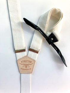 We are releasing the first of our formal “Black Tie” Suspenders / Braces with monochromatic black leather Back patch and black leather button on attachments. Gold colored brass hardware available upon request.All Stratton Suspender strap sets can be used with our vintage leather button on attachments or with our MOST popular, beautiful yet shockingly functional, leather clasp sets. A truly unique way to stand out with class! Guaranteed to not come off. More than that, the modularity of Stratton Linen Set, Back Patch, Brass Hardware, Suspenders, Braces, Black Tie, Vintage Leather, Gold Color, White And Black