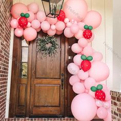 an entrance decorated with pink and green balloons