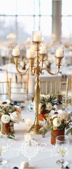 the centerpieces are decorated with flowers and candles for an elegant touch to the table