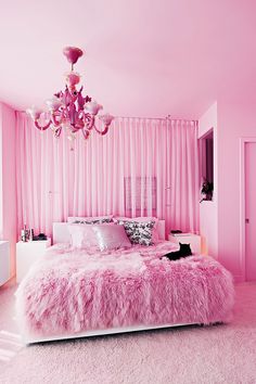 a bedroom with pink walls and carpeted flooring