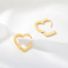 Elia Heart Hoop Earrings Part of The Kindness Collection. $2 from every item sold is donated to our featured nonprofit. Click here for our current Kindness Collection nonprofit partner information. The Elia Heart Hoop Earrings are a stylish and fashion-forward way to show your heart for Valentine's Day, Galentine's, or any other day. These earrings make a great gift that gives back because every purchase donates to charity. Show your love and make a difference with these Elia Heart Hoop Earrings Ear Huggies, Ear Cuff Piercing, Silver Heart Earrings, Heart Hoop Earrings, Heart Shaped Earrings, Heart Drop Earrings, Trendy Earrings, Valentines Jewelry, Heart Studs